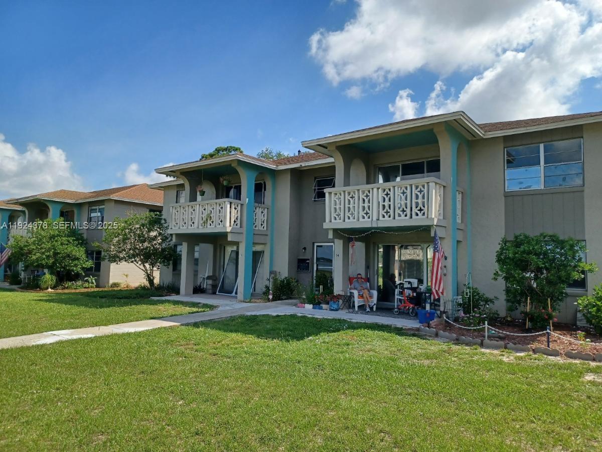 A two-story apartment building features balconies with decorative railings and teal-painted support columns — 1015 LAKEVIEW DRIVE, Sebring FL 33870, SEBRING, FL