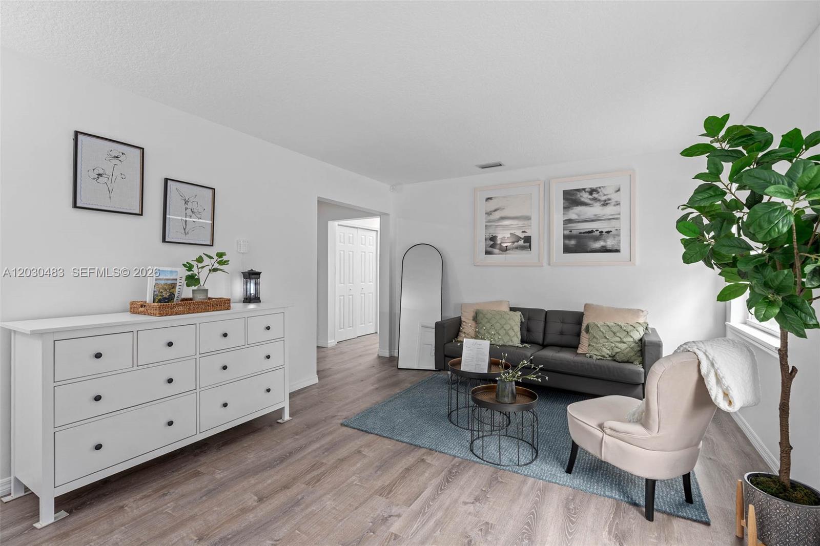 A living room features a white dresser, a grey sofa, and a beige armchair — 4255 Wee Street # 4255, Mount Dora FL 32757, MOUNT DORA, FL