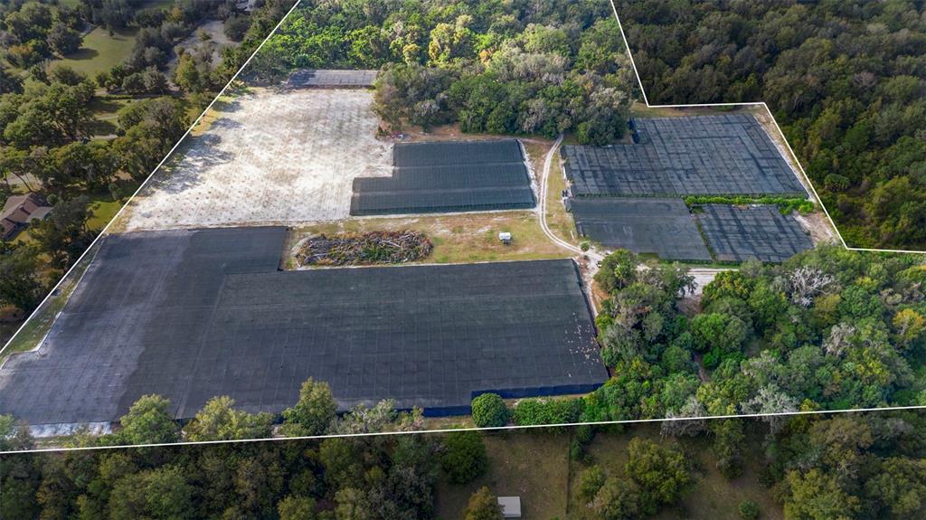 An aerial view shows a large plot of land featuring multiple agricultural shade structures — KING STREET, DELAND, FL