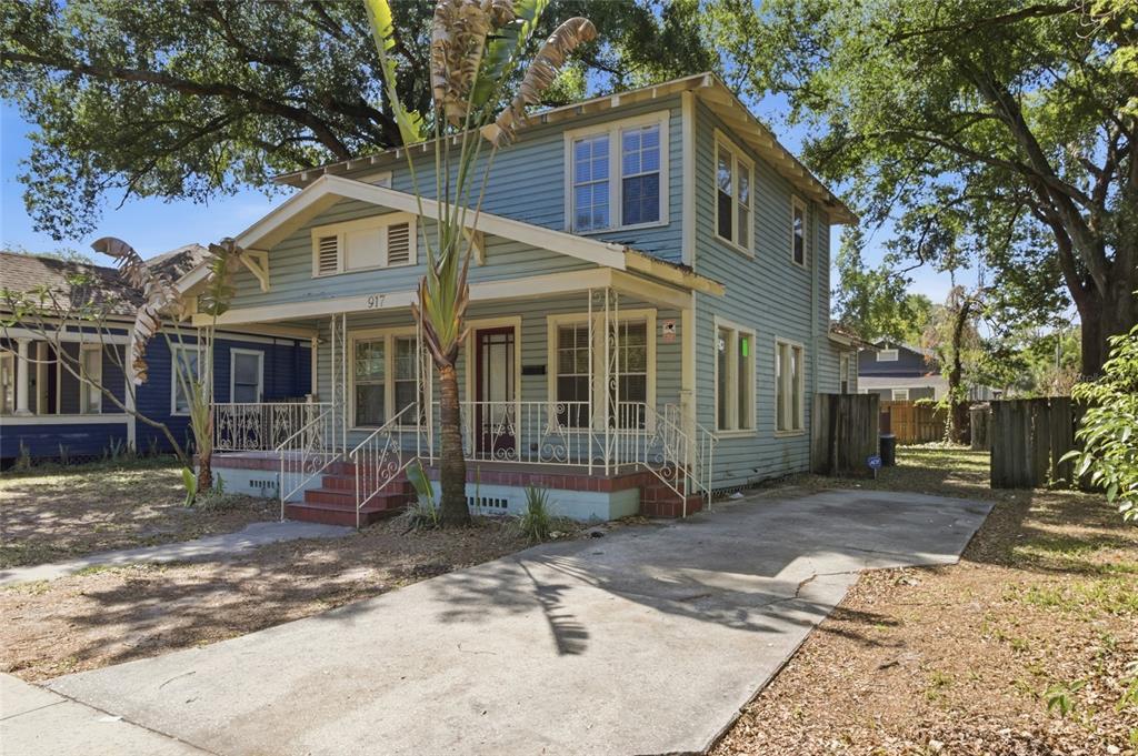 A two-story blue house with a front porch and a concrete driveway — 917 E 26TH AVENUE, TAMPA, FL