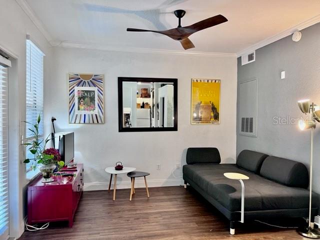 A living room features a red media console, a black sofa, and a wall mirror — 860 N ORANGE AVENUE UNIT 268, ORLANDO, FL