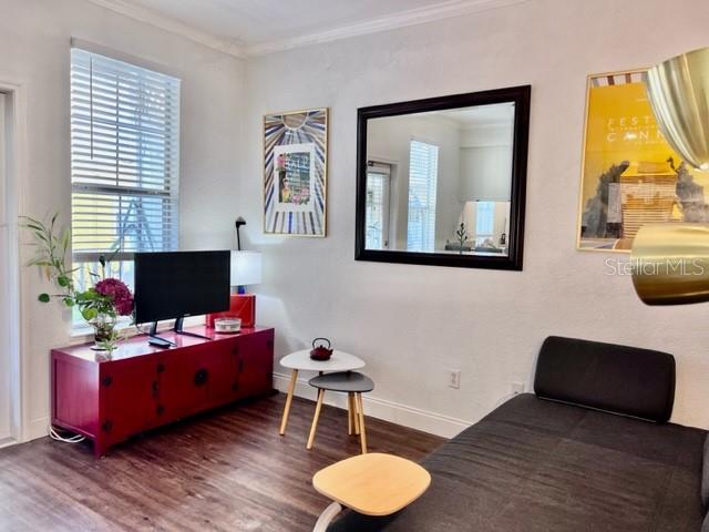 A gray sofa bed sits in a room with a framed Cannes poster and mirror — 860 N ORANGE AVENUE UNIT 268, ORLANDO, FL