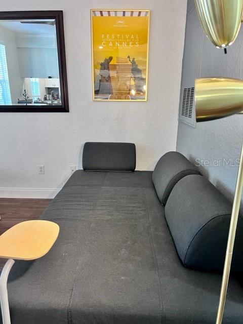 A room features a red media console, a television, nesting tables, and a large wall mirror — 860 N ORANGE AVENUE UNIT 268, ORLANDO, FL