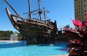 A large pirate ship structure sits in the middle of a swimming pool — 8100 POINCIANA BOULEVARD UNIT 2106, ORLANDO, FL