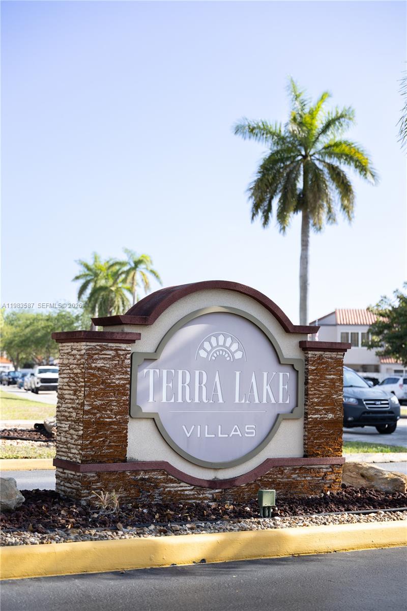 A stone monument sign displays the name Terra Lake Villas under a clear blue sky — 6110 SW 129th Pl # 1705, Miami FL 33183, MIAMI, FL