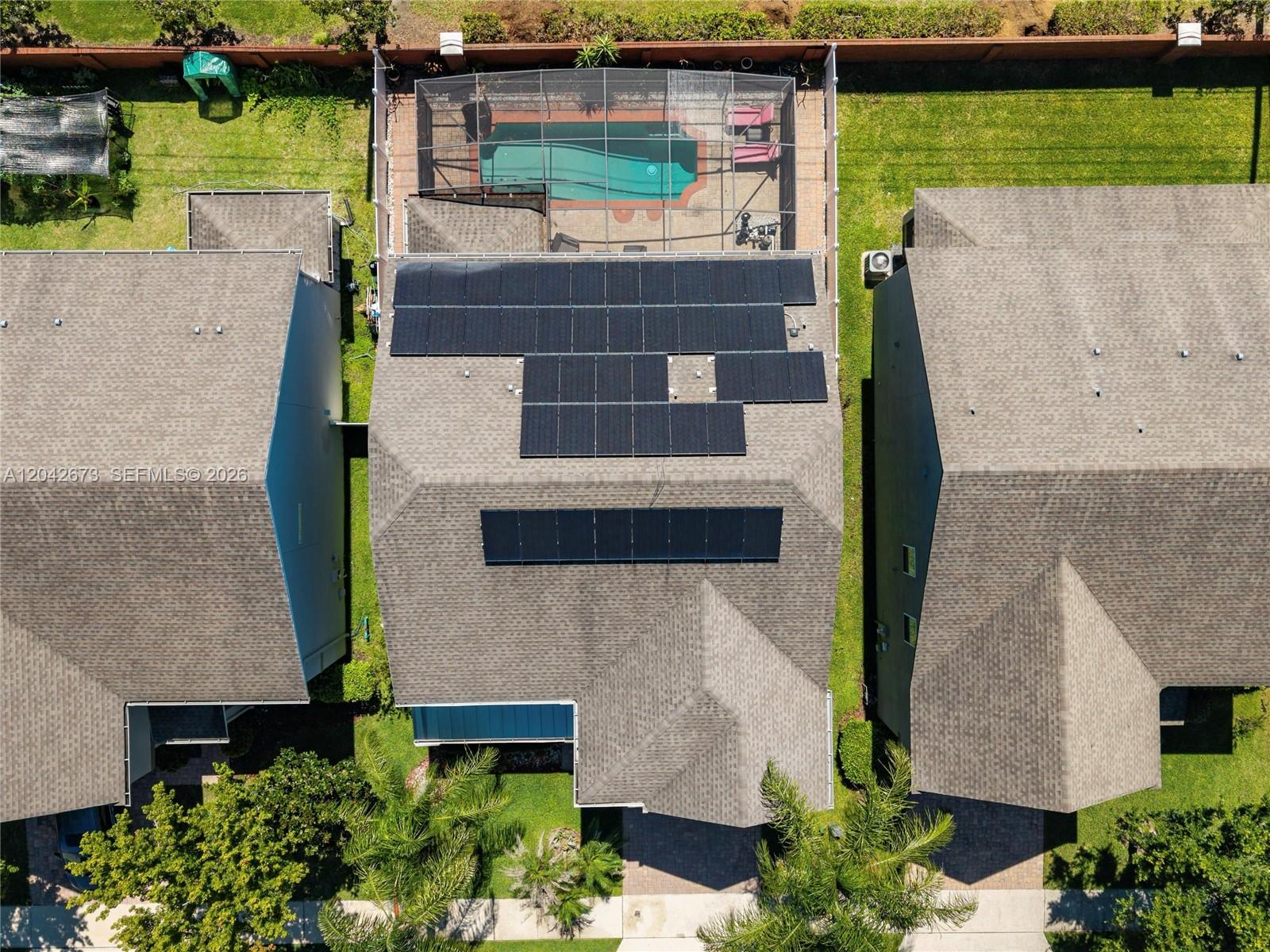 An aerial view shows a house with solar panels on the roof and a pool — 617 Marsh Reed Drive, Winter Garden FL 34787, WINTER GARDEN, FL