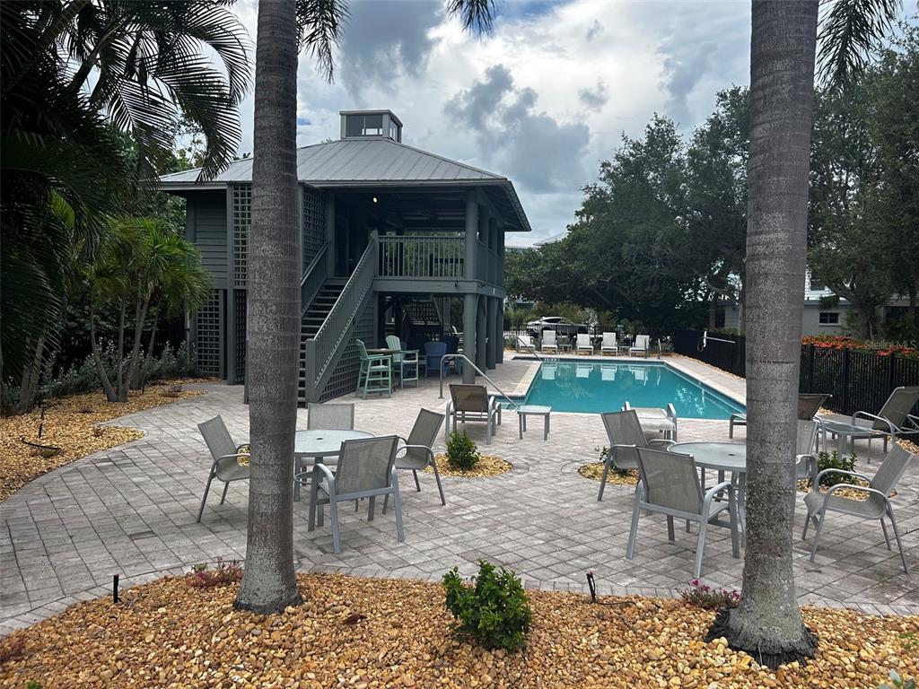 A backyard features a two-story gray structure, a swimming pool, and patio furniture — 363 FIREHOUSE LANE, LONGBOAT KEY, FL