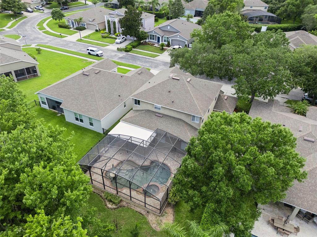 An aerial view shows a two-story house with a screened-in pool and patio area — 10109 MARSH PINE CIRCLE, ORLANDO, FL