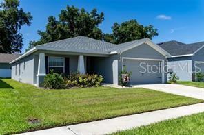 A single-story gray house with a two-car garage and a front lawn — 3882 WILLOW RIDGE DRIVE, LAKELAND, FL