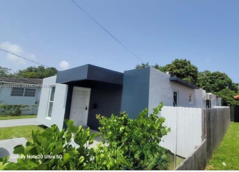 A modern, flat-roofed house with grey and dark blue exterior walls and a white fence — 2341 SW 17th Ave # 2343, Miami FL 33145, MIAMI, FL