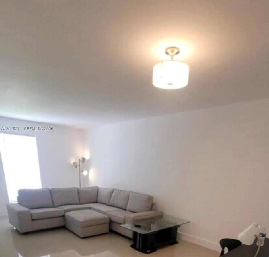 A living room features a light gray sectional sofa, a glass coffee table, and a ceiling light — 2341 SW 17th Ave # 2343, Miami FL 33145, MIAMI, FL