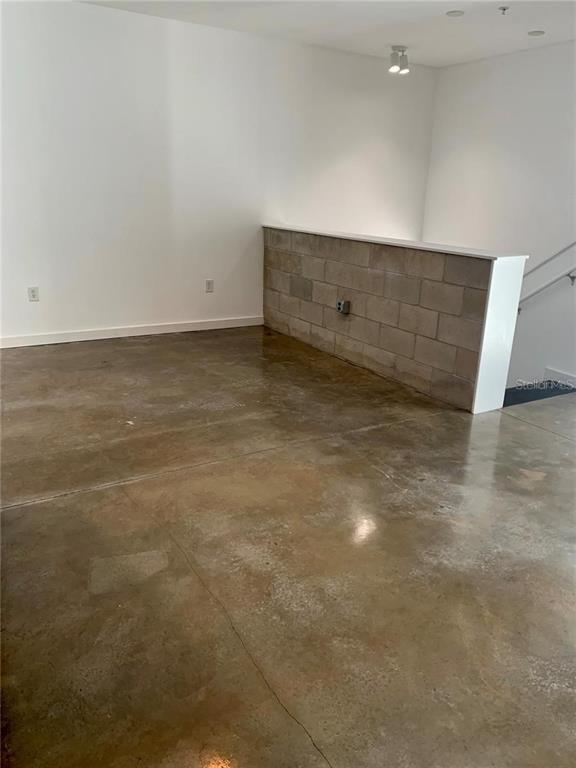 An interior room features polished concrete floors and a low concrete block partition wall — 5008 S MACDILL AVENUE UNIT 19, TAMPA, FL