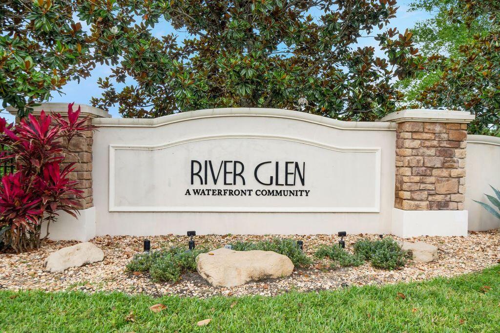 A stone and stucco monument sign for River Glen stands in a landscaped garden — 626 SW Glen Crest Way, Stuart FL 34997, STUART, FL
