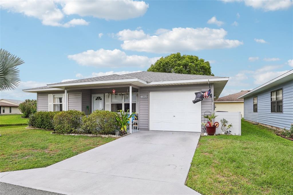 A single-story gray house with a white garage door and a concrete driveway — 4890 PLEASANT HOLLOW TRAIL, LAKELAND, FL