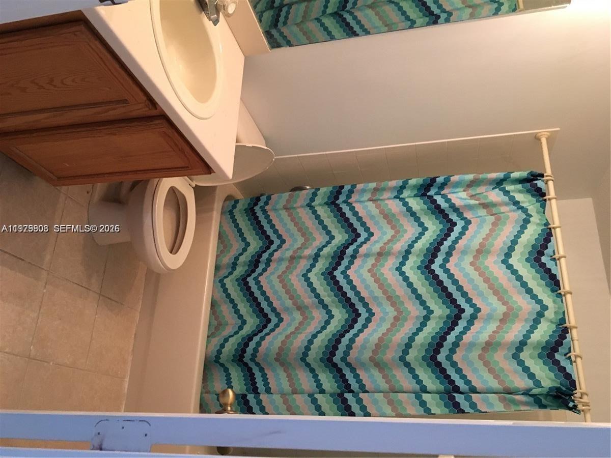 A kitchen features oak cabinets, laminate countertops, a double sink, and a black refrigerator — 7260 Sienna Ridge Dr, Lauderhill FL 33319, LAUDERHILL, FL