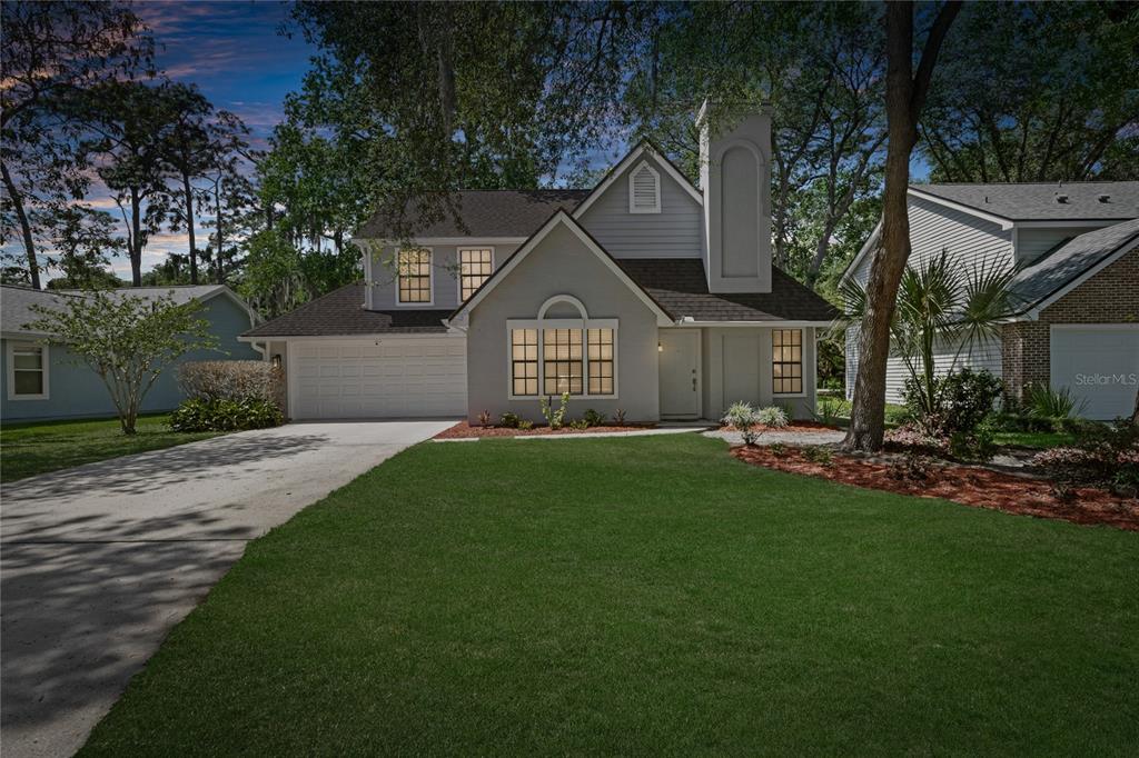 A two-story house with a gray exterior, a front-facing garage, and a large front lawn — 938 SOUTHRIDGE TRAIL, ALTAMONTE SPRINGS, FL