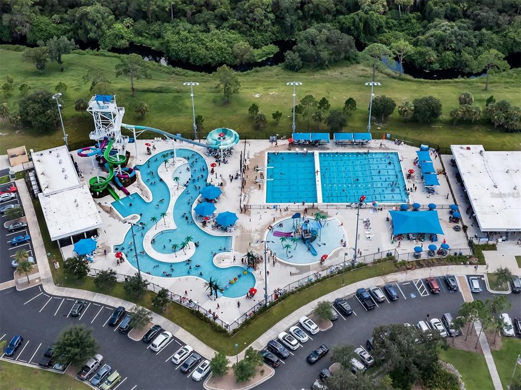 An aerial view of a community aquatic center featuring a pool, water slides, and parking — HADER ROAD, NORTH PORT, FL