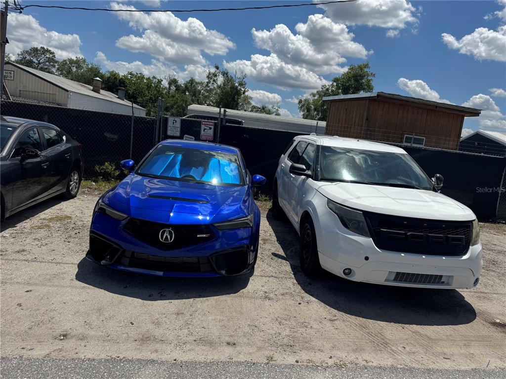 A blue Acura and a white Ford SUV are parked on a gravel lot — 1050 NURSERY ROAD, WINTER SPRINGS, FL