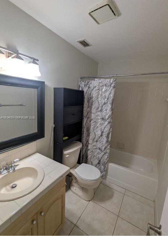 A kitchen features blue cabinets, stainless steel appliances, and a light-colored countertop — 4430 NW 92nd Way, Sunrise FL 33351, SUNRISE, FL