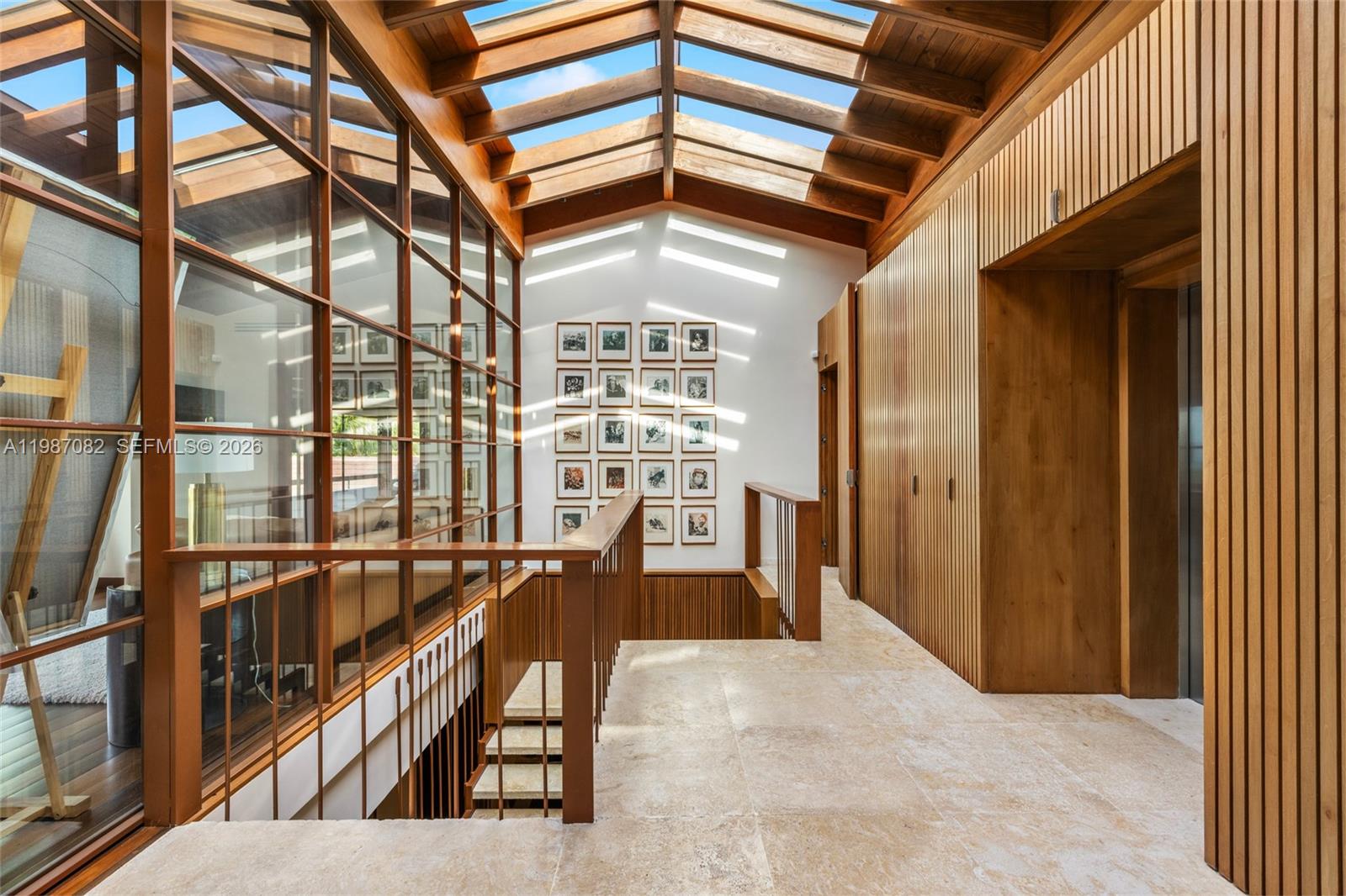 A sunlit hallway features a wooden vaulted skylight ceiling, stone flooring, and a staircase railing — Las Palmas 21 A Casa de Campo, La Romana, Dominic, FL