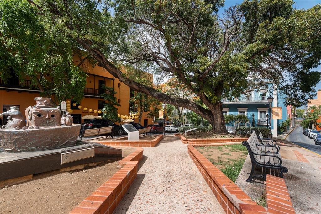 A public plaza features a bronze sculpture, park benches, and a large tree — 70 CALETA DE SAN JUAN UNIT 2, OLD SAN JUAN, PR