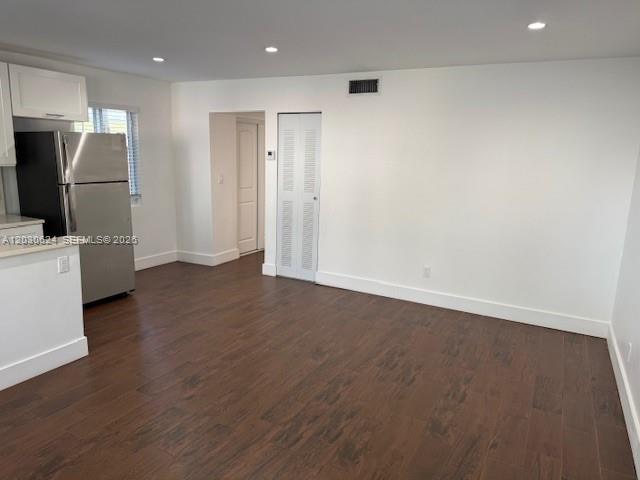 A kitchen area with stainless steel appliances, white cabinets, and dark wood-look flooring — 2006 Calais Dr # 1, Miami Beach FL 33141, MIAMI BEACH, FL