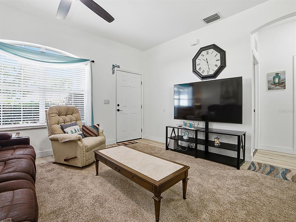 A living room features a television on a stand, a recliner, and a coffee table — 2632 NE 27TH STREET, OCALA, FL