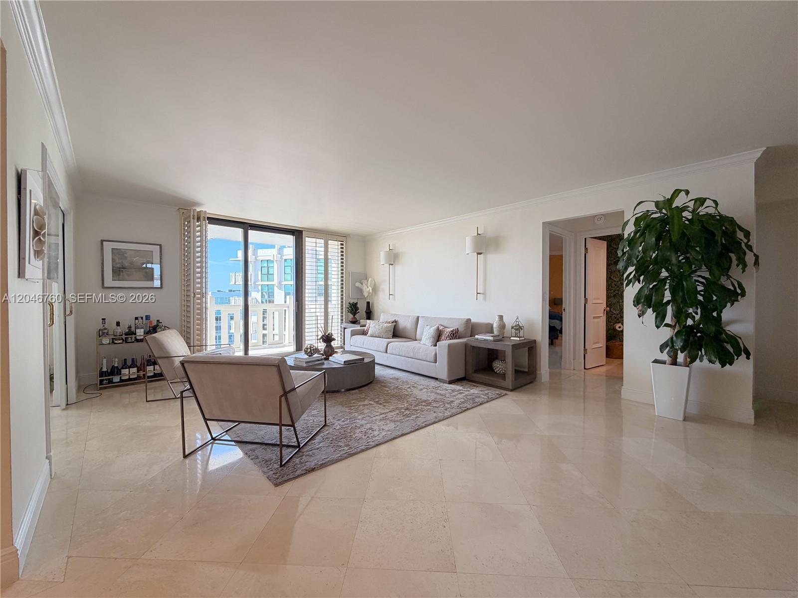 A bright living room features light-colored tile floors, a neutral sofa, and a balcony view — 1111 Crandon Blvd # C1104, Key Biscayne FL 33149, KEY BISCAYNE, FL