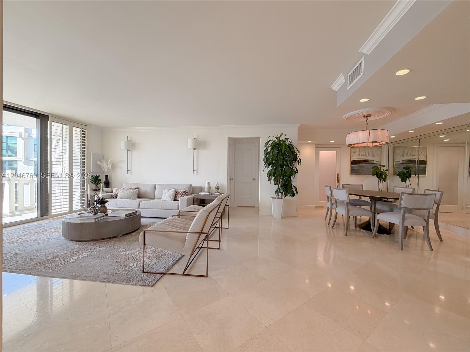 A bright, open-concept living and dining area features light tile floors and modern neutral furniture — 1111 Crandon Blvd # C1104, Key Biscayne FL 33149, KEY BISCAYNE, FL