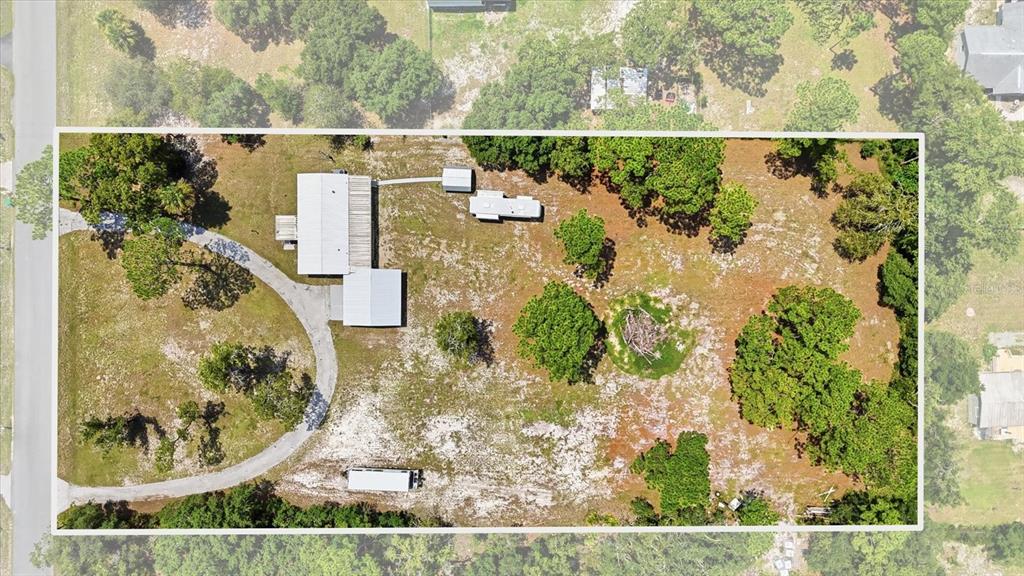 An aerial view shows a house, a detached trailer, and a driveway on a wooded lot — 7230 S SONATA AVENUE, HOMOSASSA, FL