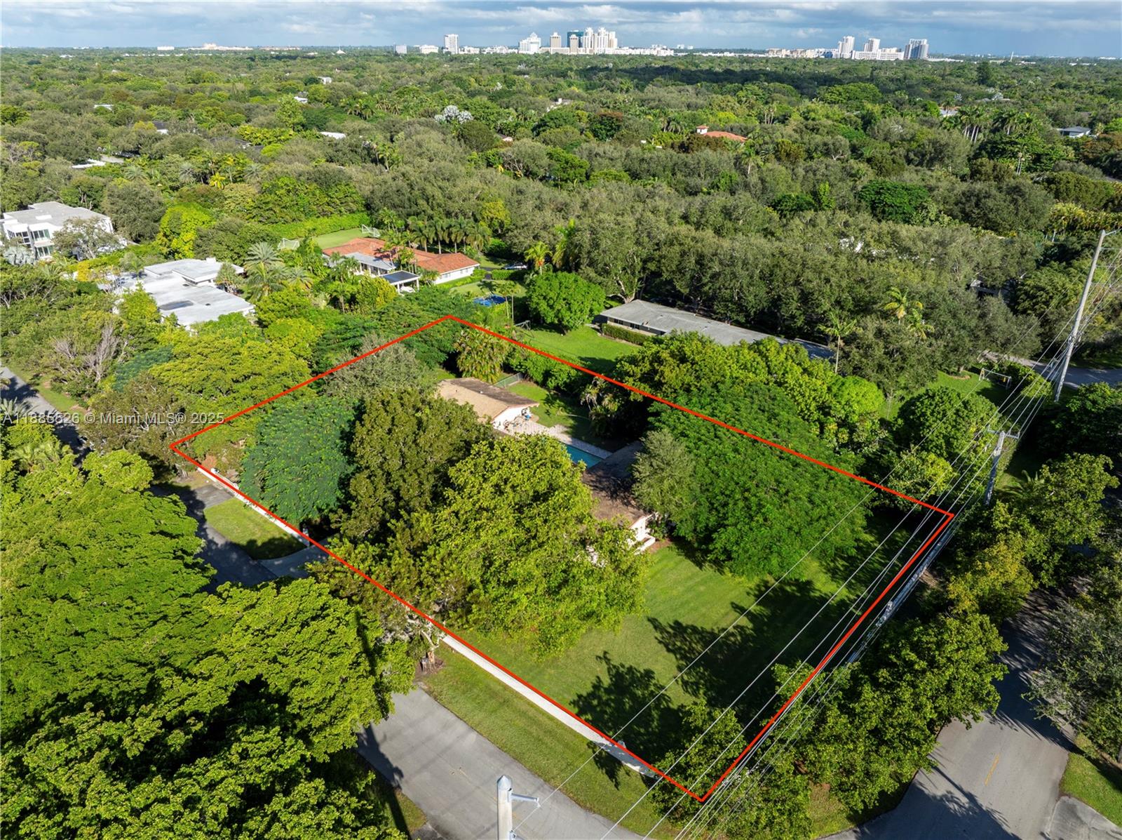 An aerial view shows a house with a pool on a large, tree-filled lot — 6201 SW 114th St, Pinecrest FL 33156, PINECREST, FL