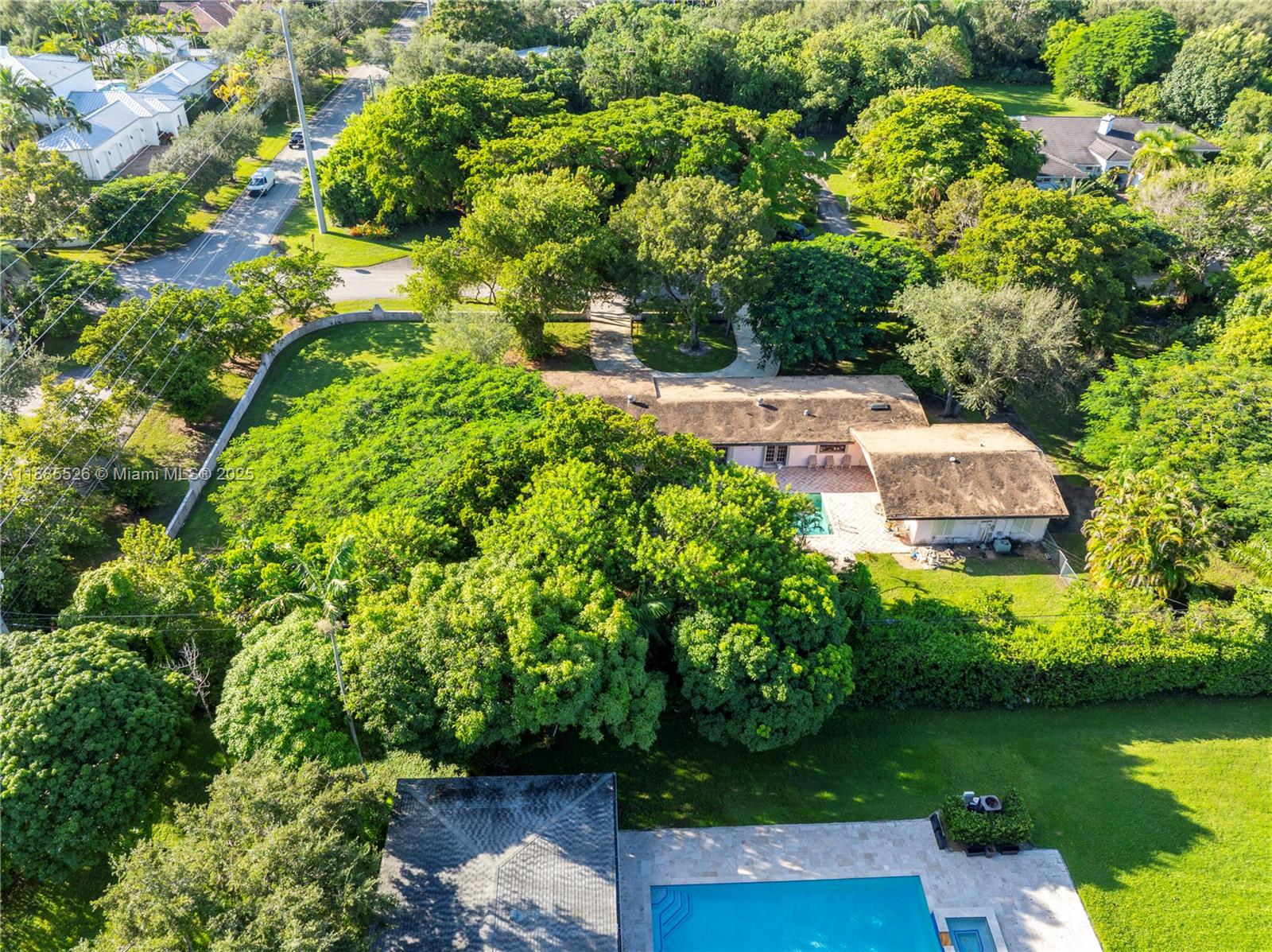 An aerial view shows a house with a pool, surrounded by dense trees and lawns — 6201 SW 114th St, Pinecrest FL 33156, PINECREST, FL