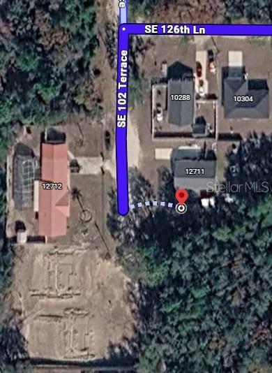This is an aerial map showing residential properties and street names — SE 102ND TERRACE, OCKLAWAHA, FL