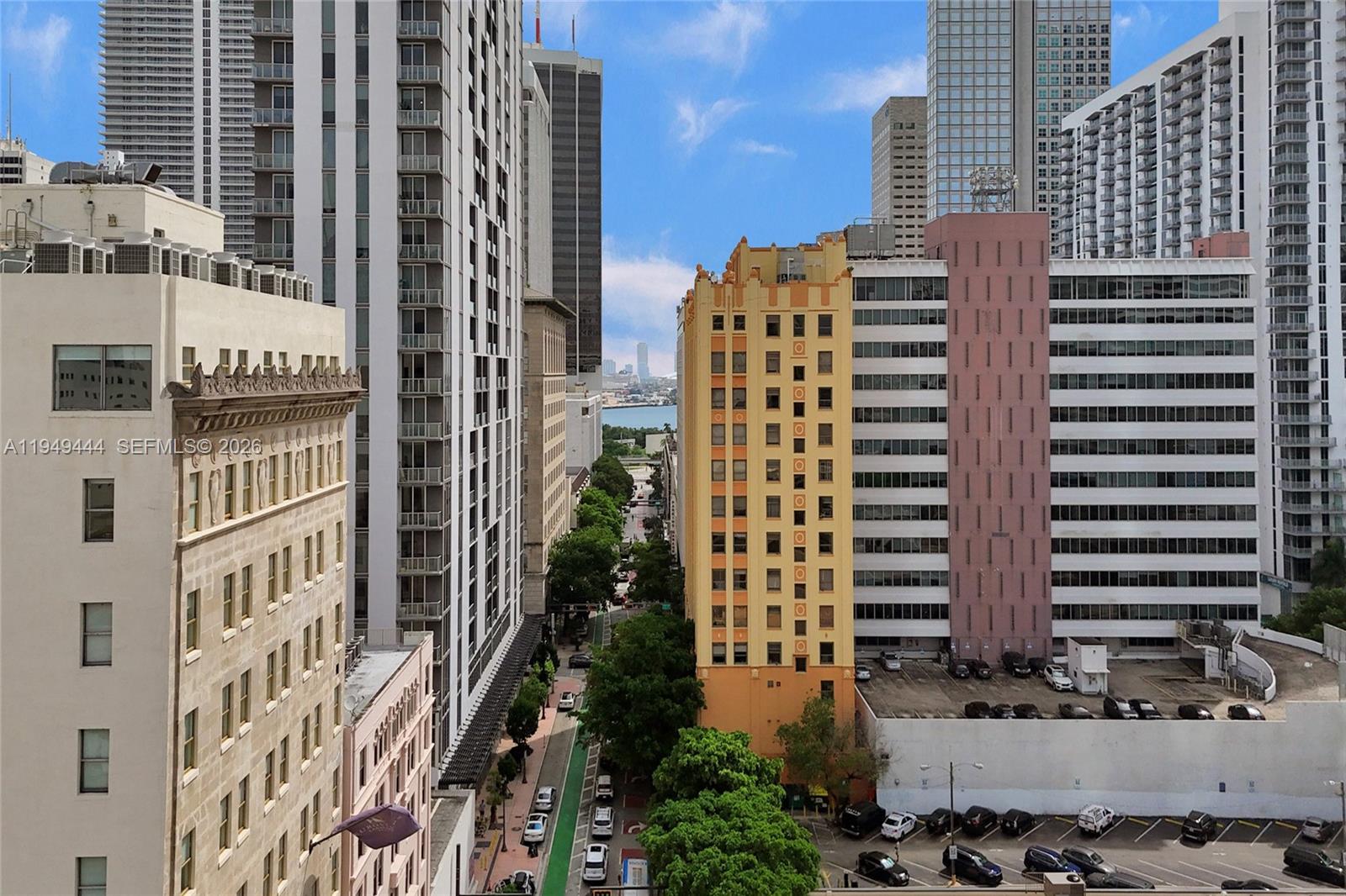 An elevated view of a city street lined with tall buildings and trees — 168 SE 1st St # 1200, Miami FL 33131, MIAMI, FL