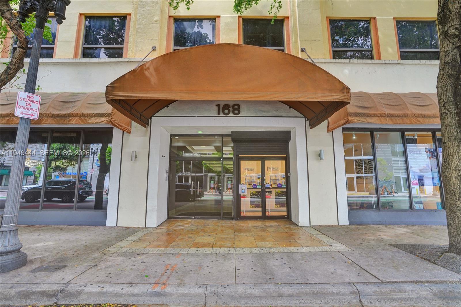 The exterior of a building entrance features a brown awning over glass doors at 168 — 168 SE 1st St # 1200, Miami FL 33131, MIAMI, FL