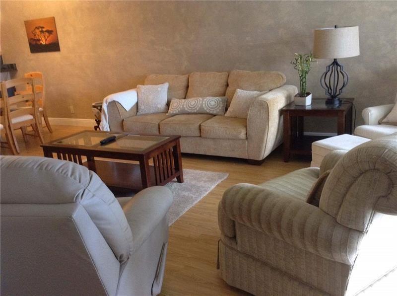 A living room features a beige sofa, two armchairs, a coffee table, and a side table — 3150 N Course Lane # 207, Pompano Beach FL 33069, POMPANO BEACH, FL