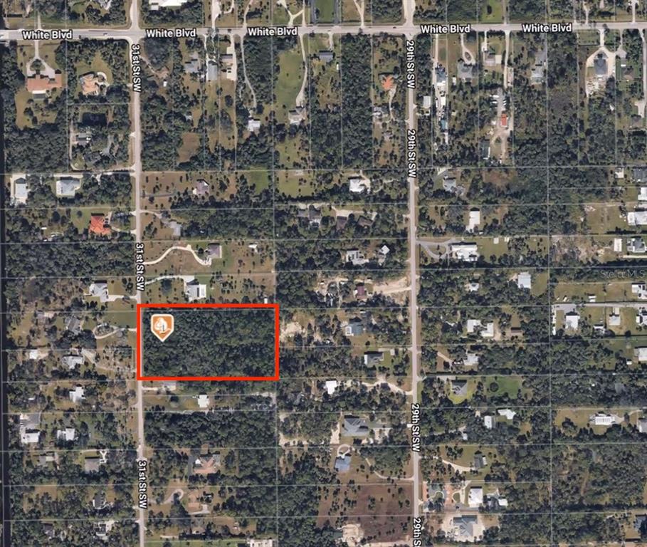 This is an aerial map showing a rectangular plot of land highlighted in red — 00 SW 31 STREET, NAPLES, FL