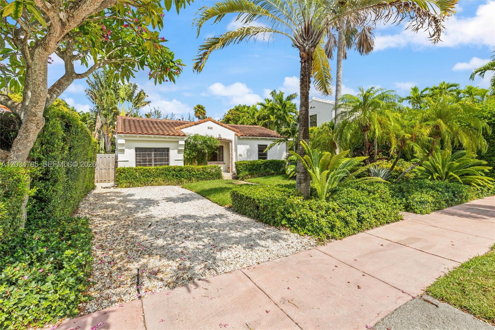 A single-story house with a gravel driveway, tiled roof, and lush tropical landscaping — 4531 Sheridan Ave, Miami Beach FL 33140, MIAMI BEACH, FL