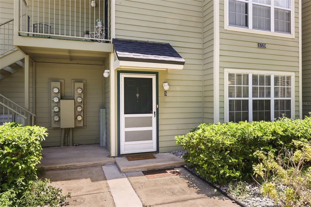 The exterior of a light green multi-unit building features a front door with a screen — 3729 S LAKE ORLANDO PARKWAY UNIT 5, ORLANDO, FL