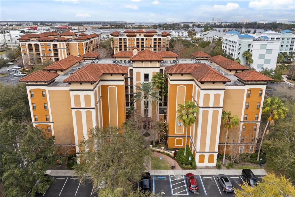 An aerial view of a multi-story apartment building with a terracotta tile roof — 12539 FLORIDAYS RESORT DRIVE UNIT 404D, ORLANDO, FL
