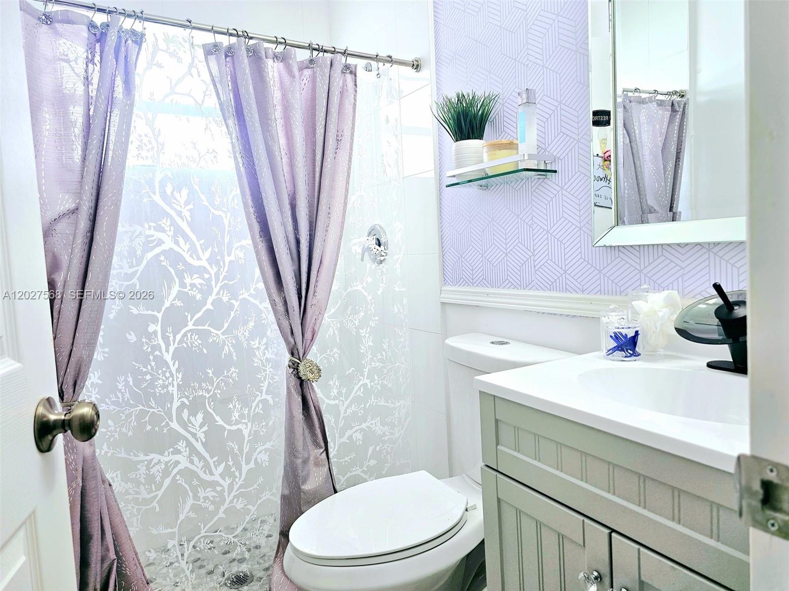 A bathroom features a light purple patterned shower curtain, a vanity, and a toilet — 4890 NW 7th St # 2, Plantation FL 33317, PLANTATION, FL