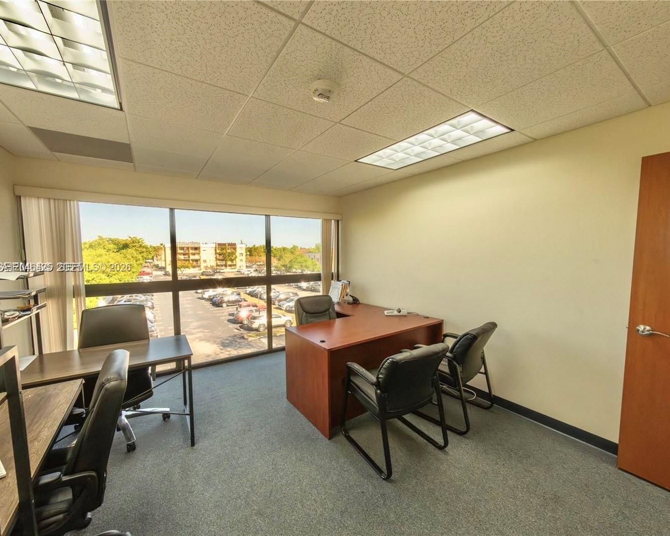 An office with a large desk, chairs, and a window overlooking a parking lot — 10691 SW 88th St, Miami FL 33176, MIAMI, FL
