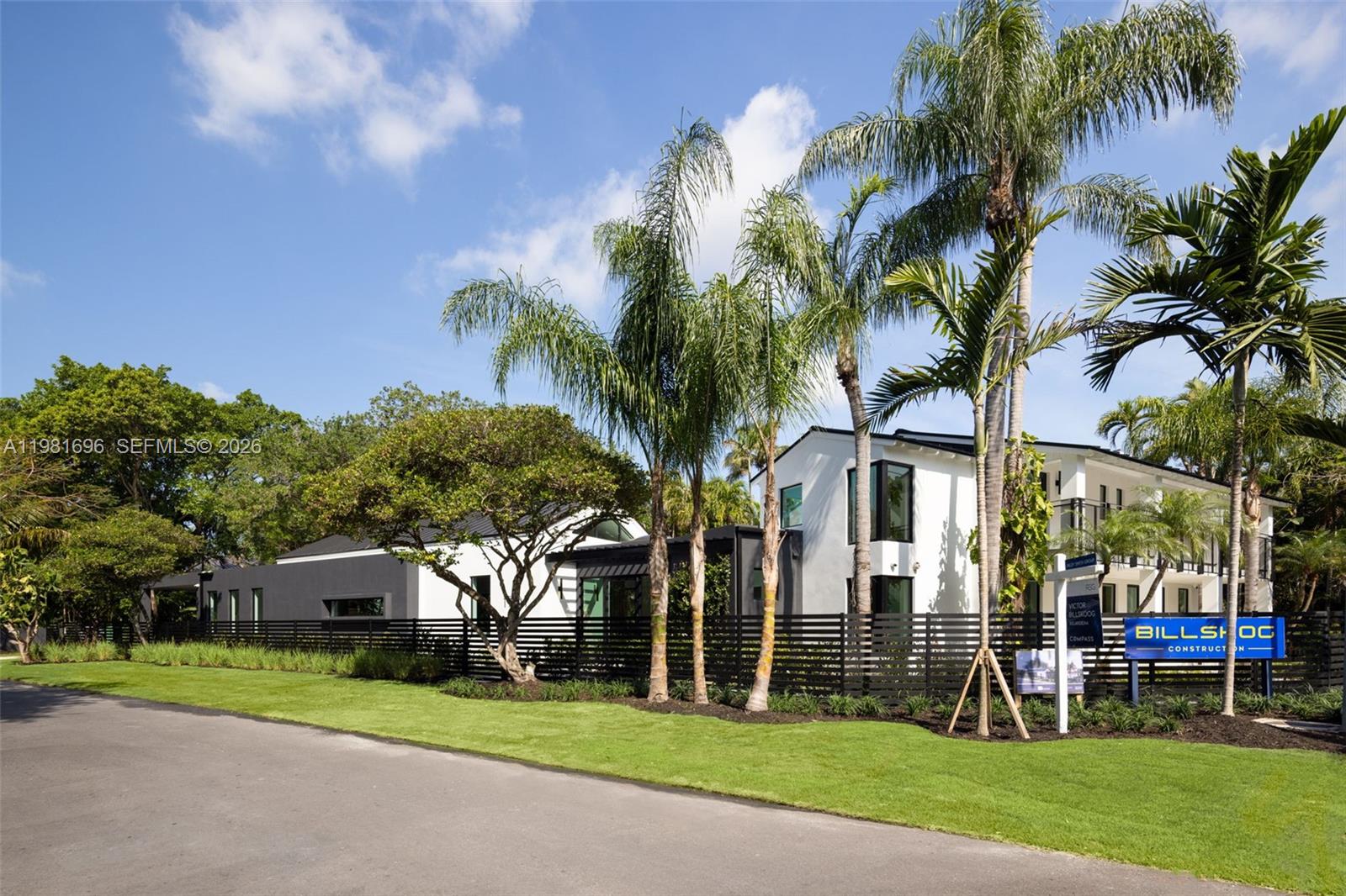A modern two-story house with a black fence, palm trees, and a construction sign — 1701 Micanopy Ave, Coconut Grove FL 33133, COCONUT GROVE, FL