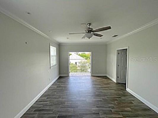 An empty room with gray walls, wood-look tile flooring, a ceiling fan, and a balcony door — 308 W BRIDGERS AVENUE, AUBURNDALE, FL
