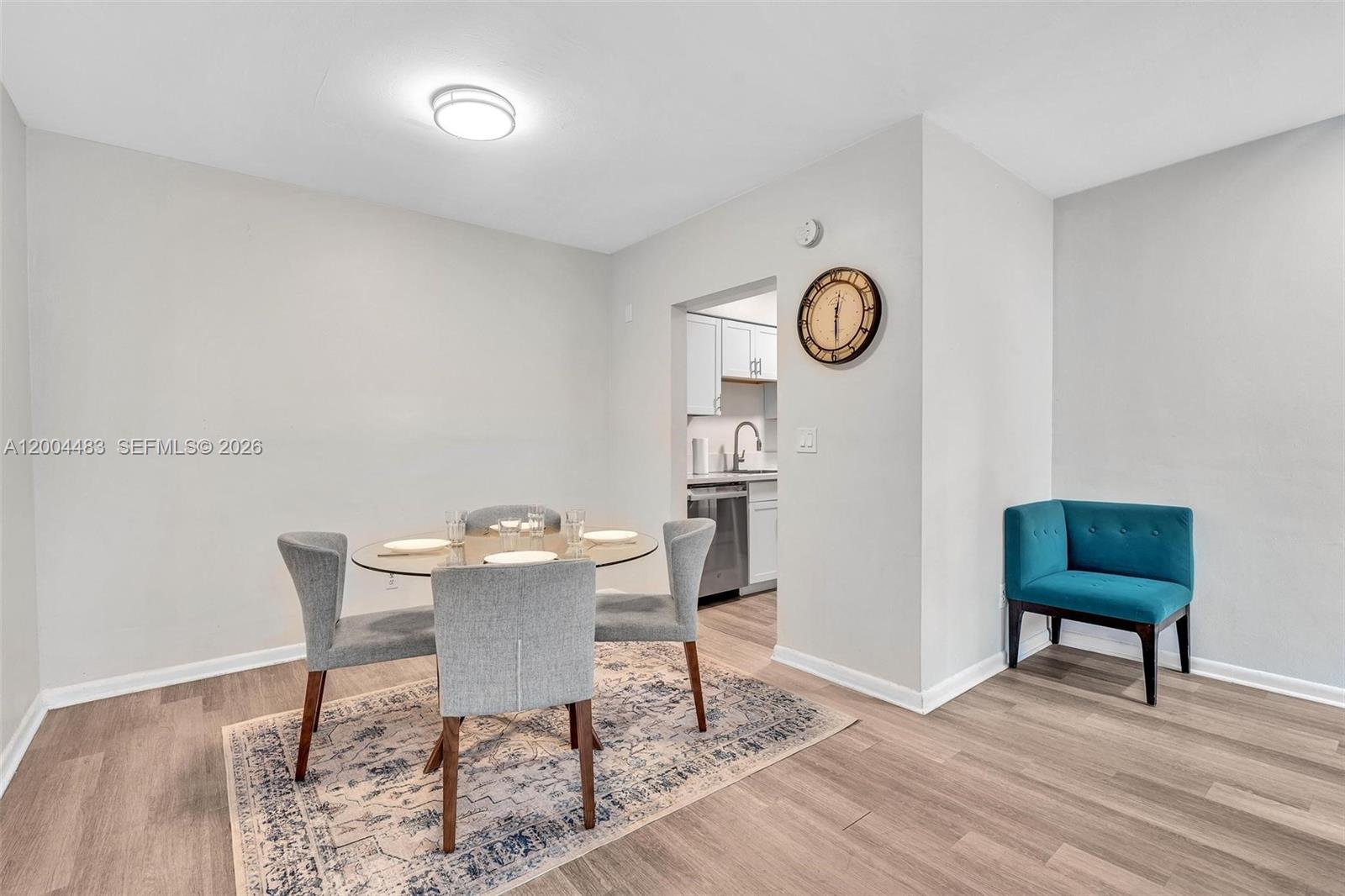 A dining area features a glass table with four grey chairs on a patterned rug — 10006 E Bay Harbor Dr # 17, Bay Harbor Islands FL 33154, BAY HARBOR ISLANDS, FL