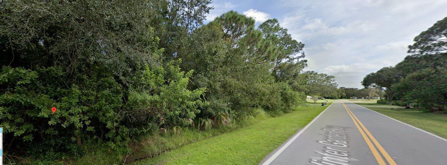 A vacant, wooded lot sits along the side of a paved two-lane road — 6906 Winter Garden Parkway, FL 34951, FL