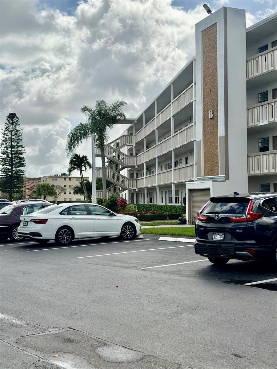 A multi-story apartment building with exterior staircases and a parking lot in the foreground — 3035 Rexford, Boca Raton FL 33434, BOCA RATON, FL