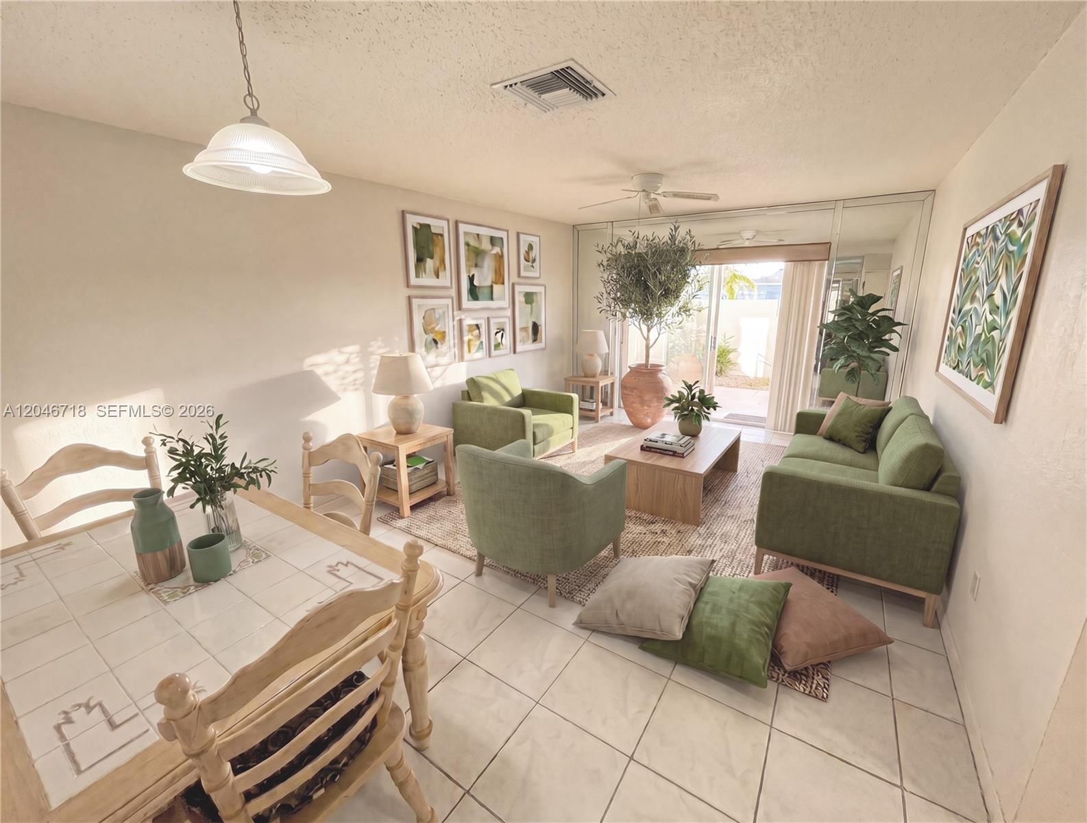 This living and dining area features green furniture, tiled floors, and a large sliding glass door — 2800 NW 56th Ave # B207, Lauderhill FL 33313, LAUDERHILL, FL
