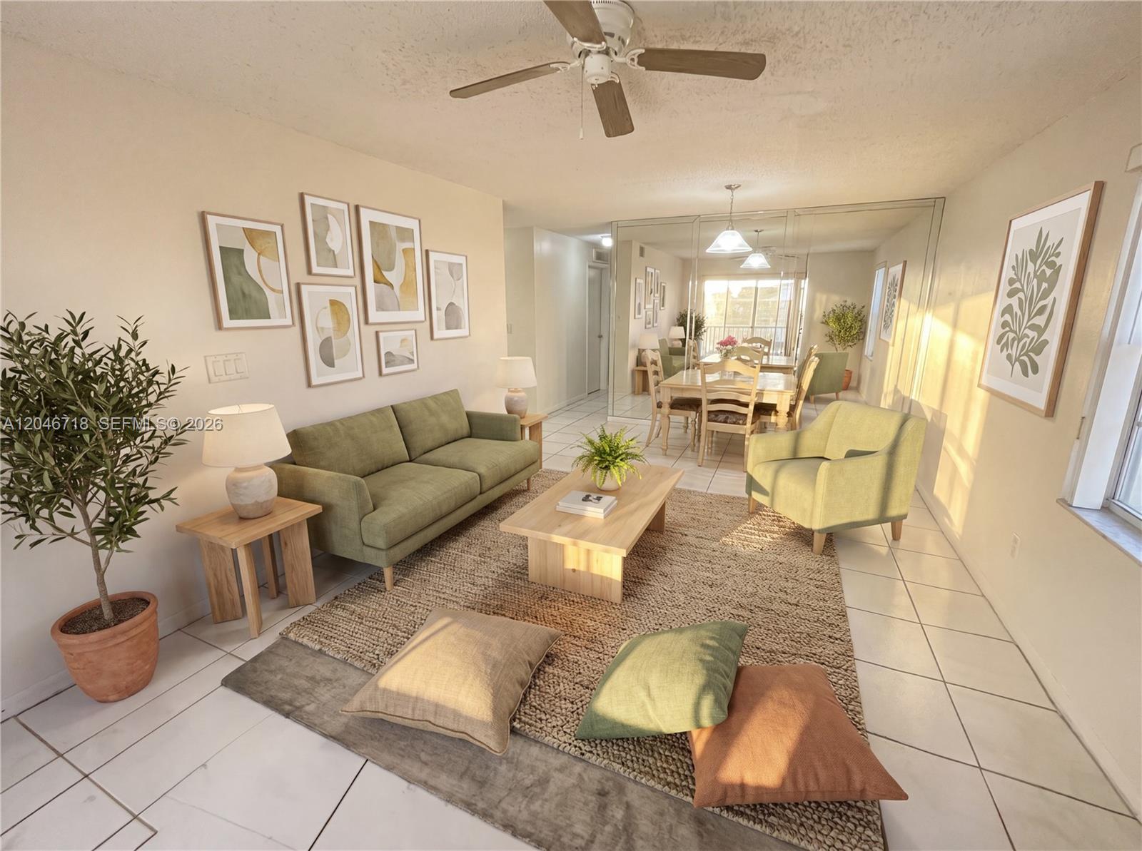 A living room features a green sofa, an armchair, a coffee table, and floor cushions — 2800 NW 56th Ave # B207, Lauderhill FL 33313, LAUDERHILL, FL
