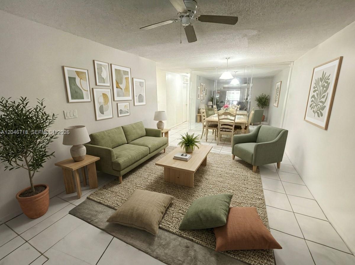 A living room features a green sofa, an armchair, a coffee table, and tiled floors — 2800 NW 56th Ave # B207, Lauderhill FL 33313, LAUDERHILL, FL